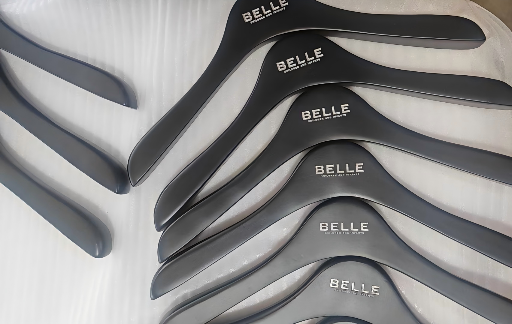 Custom black lacquer wooden hangers with laser engraved BELLE logo